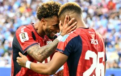 Cape Verde's forward Helio Varela (26) celebrates with teammate Ryan Mendes after scoring his team's equaliser in a 2-2 draw with Uruguay