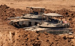 This picture taken from a position in the Upper Galilee in northern Israel shows Israeli tanks positioned along the border with southern Lebanon on June 22, 2026