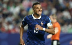 Kylian Mbappe admitted the long storm delay took its toll on France against Iraq -- but he scored two more World Cup goals in their 3-0 win