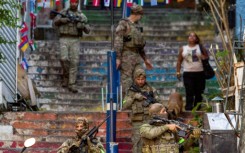 Brazilian special police forces patrol a street during an operation in the Santa Marta favela