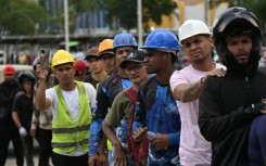 First responders from France walk along a street in hard-hit La Guaira state