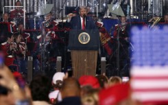 US President Donald Trump raises a fist as he speaks during the kick-off celebration for the "Great American State Fair" on the National Mall in Washington, DC, to celebrate the 250th anniversary of US independence