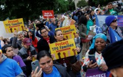 Demonstrators chanted and held signs outside the US Supreme Court as it weighed ending temporary protected status for Haitians and Syrians