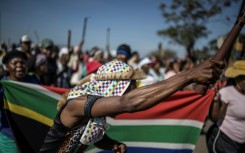 Protests have been fronted by men carrying sticks and shields