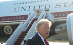 President Donald Trump speaks to the press before he boards Air Force One for his first flight aboard the Boeing 747-8 that Qatar gifted to the United States