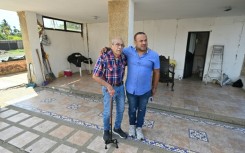Engineer Elias Chayeb (L) and his son, engineer Elias Eduardo Chayeb, were relieved upon seeing a small residential building they helped build had withstood the two violent earthquakes in Venezuela