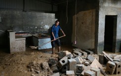 Residents of China's Liulan began the long process of cleaning up their wrecked homes after devastating storms