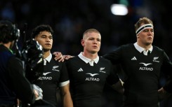 German-born Anton Segner (centre) sings the national anthem as he lines up with fellow All Blacks Wallace Sititi (left) and Sam Darry before the Nations Championship match against Italy in Wellington