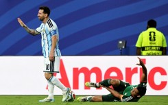 Argentina forward Lionel Messi gestures after fouling Algeria's Aissa Mandi, which pundits say should have earned him a red card