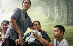 Relatives of victims of the fire waiting at the Police General Hospital in Bangkok on July 14