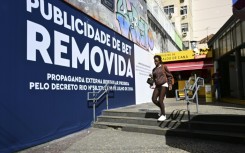 Rio de Janeiro municipal workers went through the streets this week covering up billboards with the message: 'Betting ad REMOVED'