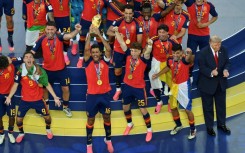 Spain's midfielder #16 Rodri (front C) lifts the trophy with Spain's players next to US President Donald Trump (R) during the final ceremony after the 2026 World Cup