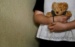 Bobo a woman who suffered persistent child sexual abuse for several years, holds a teddy bear