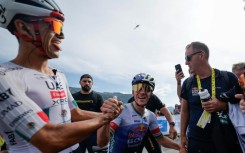 A leaner meaner Remco Evenepoel (C) has proved he can mix it with the best climbers at the Tour de France