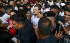 Security personnel detain Indian opposition leader Rahul Gandhi (C) during a protest outside Prime Minister Narendra Modi's residence in New Delhi on Tuesday