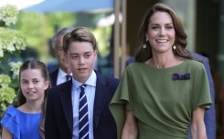 Britain's Prince George of Wales, flanked by Princess Catherine and Princess Charlotte, has become a teenager
