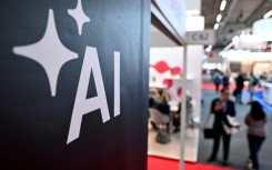 People walk past a banner for AI at the 2024 Frankfurt book fair