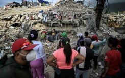 People search for bodies amid the rubble of a building in Caraballeda, Venezuela, on July 22, 2026