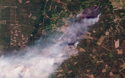 This handout satellite photograph taken on July 24, 2026 and released by 2026 Planet Labs PBC shows smoke rising from the wildfire in Le Porge and Lege-Cap-Ferret in France