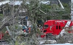 Rescue workers outside the damaged Aeon Mall Kumamoto shopping center in southwestern Japan following a major earthquake.