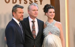 British-US director Christopher Nolan is flanked by Matt Damon, who plays Odysseus and Anne Hathaway, who plays Penelope, at the premiere of "The Odyssey" in New York