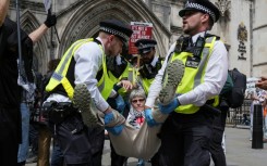 Police remove protesters from outside the Royal Courts Of Justice in central London in June