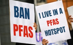 Environmental activists hold placards during a demonstration against PFAS chemicals next to the EU Commission headquarters in Brussels in March 2026