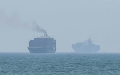 Cargo ships anchoring near the Strait of Hormuz off the eastern coast of the United Arab Emirates at Khor Fakkan