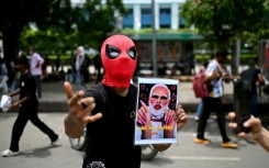 A Cockroach Janta Party supporter holds a doctored picture of India's Prime Minister Narendra Modi at a rally in New Delhi on July 25. Modi said he wanted to "forgive" protesters who abused him