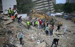 Rescue teams and volunteers search for bodies amid the rubble of a collapsed building in Caraballeda, Venezuela, on August 3, 2026