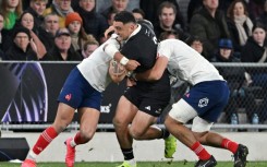 New Zealand hooker Codie Taylor (C) is tackled during a 2025 Test against France in Dunedin.