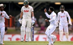 Bangladesh bowler Mehidy Hasan Miraz (2nd R) after dismissing Australia's batsman Pat Cummins in Darwin