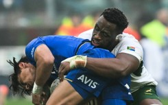 South Africa captain Siya Kolisi (R) makes a tackle during a tour victory over Italy last November.