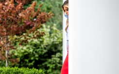 US First Lady Melania Trump arrives to host an event in the Rose Garden of the White House, in Washington, DC, on August 20, 2026, her first public appearance in a month