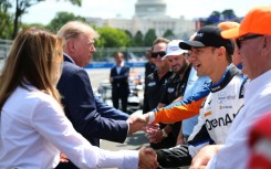 US President Donald Trump and First Lady Melania Trump, at left, greet IndyCar drivers before the start of the Freedom 250 Grand Prix on the streets of Washington