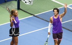 Serena Williams and Carlos Alcaraz salute the crowd after winning their mixed doubles opener at the US Open