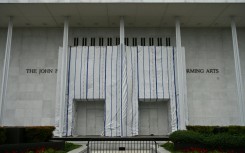A tarpaulin covers the facade of the Kennedy Center where President Donald Trump's name was removed