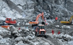 Excavators work during recovery efforts at the site of the destroyed Gyirong Port border crossing in China’s western Tibet region