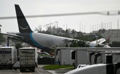 The tail section of a cargo plane is seen at Miami International Airport after it overshot the runway
