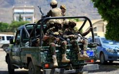 Yemen's Houthi armed forces patrol as Yemeni prisoners loyal to the Houthi authorities arrive in the capital Sanaa on September 12