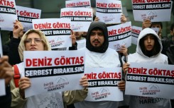 Protesters gathered outside court with placards reading: 'Release Deniz Goktas'
