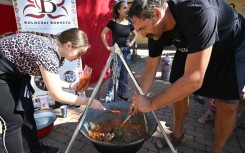 Teams competing in a cooking contests poured generous amounts of paprika into their cauldrons
