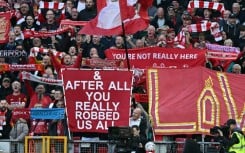 Liverpool fans hold signs mocking Manchester City's financial scandal