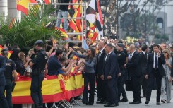 Spain's Queen Letizia shakes hands with people lining the streets of Ceuta
