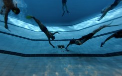 Underwater hockey players take part in the 2026 HKUWHA Under Water Hockey tournament in Hong Kong on October 17, 2026. The annual underwater hockey tournament, ominously advertised as "physical hell", nevertheless drew a roster of hardcore enthusiasts from countries across Asia.