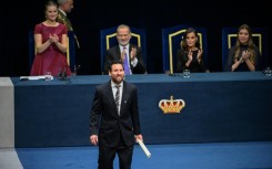 Considered the greatest footballer of all time by many, Lionel Messi (C) received his prize from Princess Leonor (L)