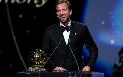 Bayern Munich and England forward Harry Kane smiles after winning the Ballon d'Or.